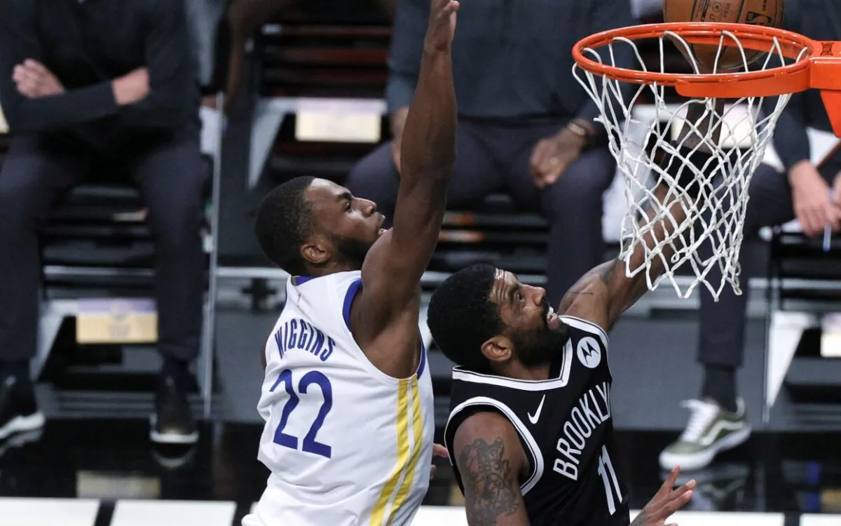 Kyrie Irving #11 of the Brooklyn Nets attempts a layup against Andrew Wiggins #22 of the Golden State Warriors during the second half at Barclays Center on December 22, 2020 (Sarah Stier/Getty Images)