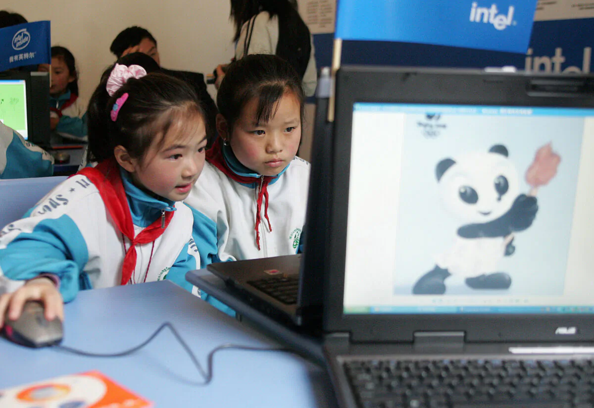 Students use computers to gather information in the Shawan Primary School in Wolong of Sichuan Province, China on May 20, 2005. (China Photos/Getty Images)
