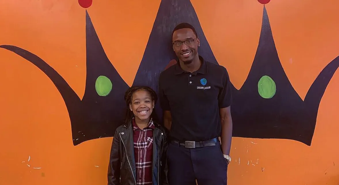 Andre with a financial literacy student. (Courtesy of Andre Henry)