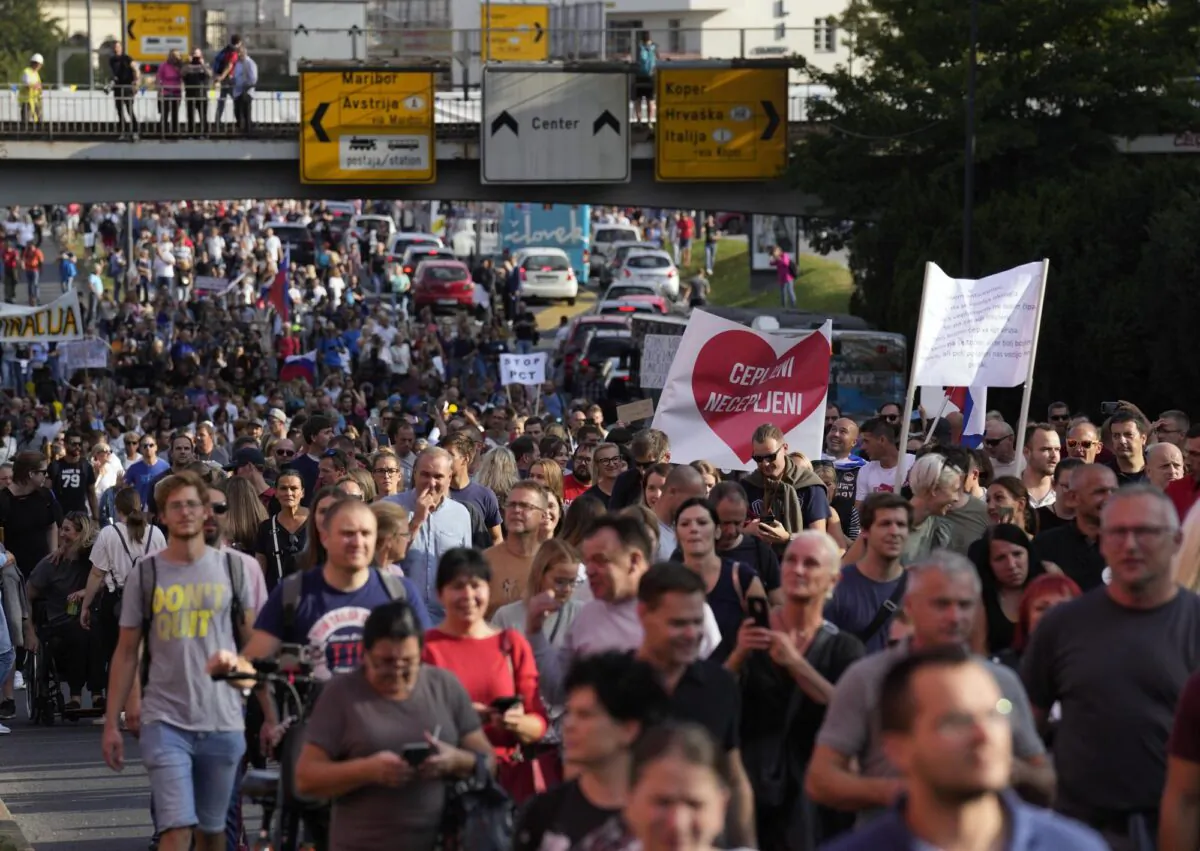 People march down a street during a protest against government-imposed COVID-19 measures in Ljubljana, Slovenia, on Sept. 29, 2021. (Darko Bandic/AP Photo)