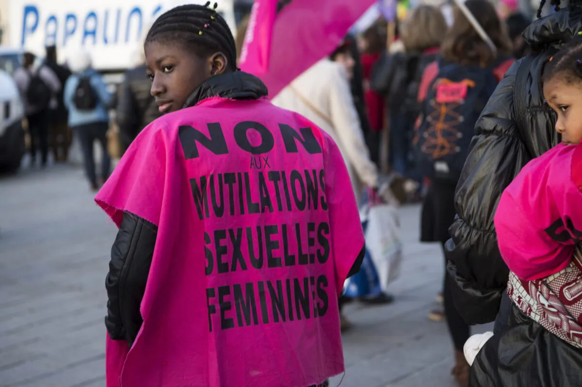 A woman wears a jersey reading "No to female genital mutilation" during a demonstration to defend women's rights on International Women's Day in Marseille, France, on March 8, 2018.
(Bertrand Langlois/AFP via Getty Images)