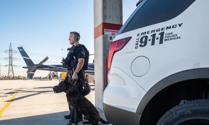 Los Angeles Police Department K9 officers prepare for an operation in Los Angeles on Dec. 13, 2018. (John Fredricks/The Epoch Times)