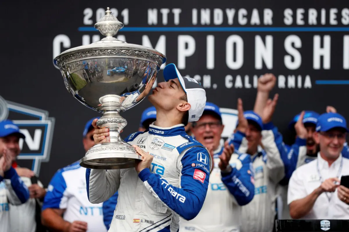 NTT IndyCar Series winner Alex Palou (C) celebrates with the trophy after taking fourth place in an IndyCar auto race at the Grand Prix of Long Beach in Long Beach, Calif., on Sept. 26, 2021. (Alex Gallardo/AP Photo)