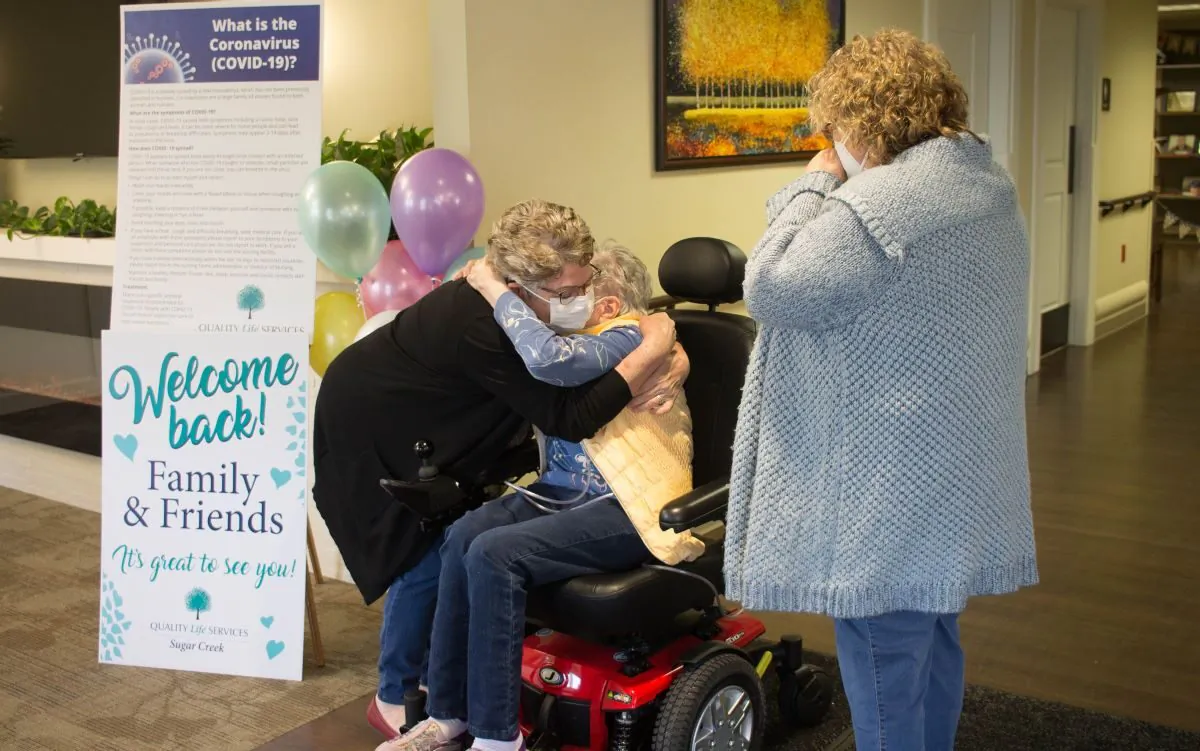 A nursing home resident and loved ones reunite at a Quality Life Services facility in western Pennsylvania, after being separated due to COVID-19. 
(Courtesy of the Pennsylvania Health Care Association)
