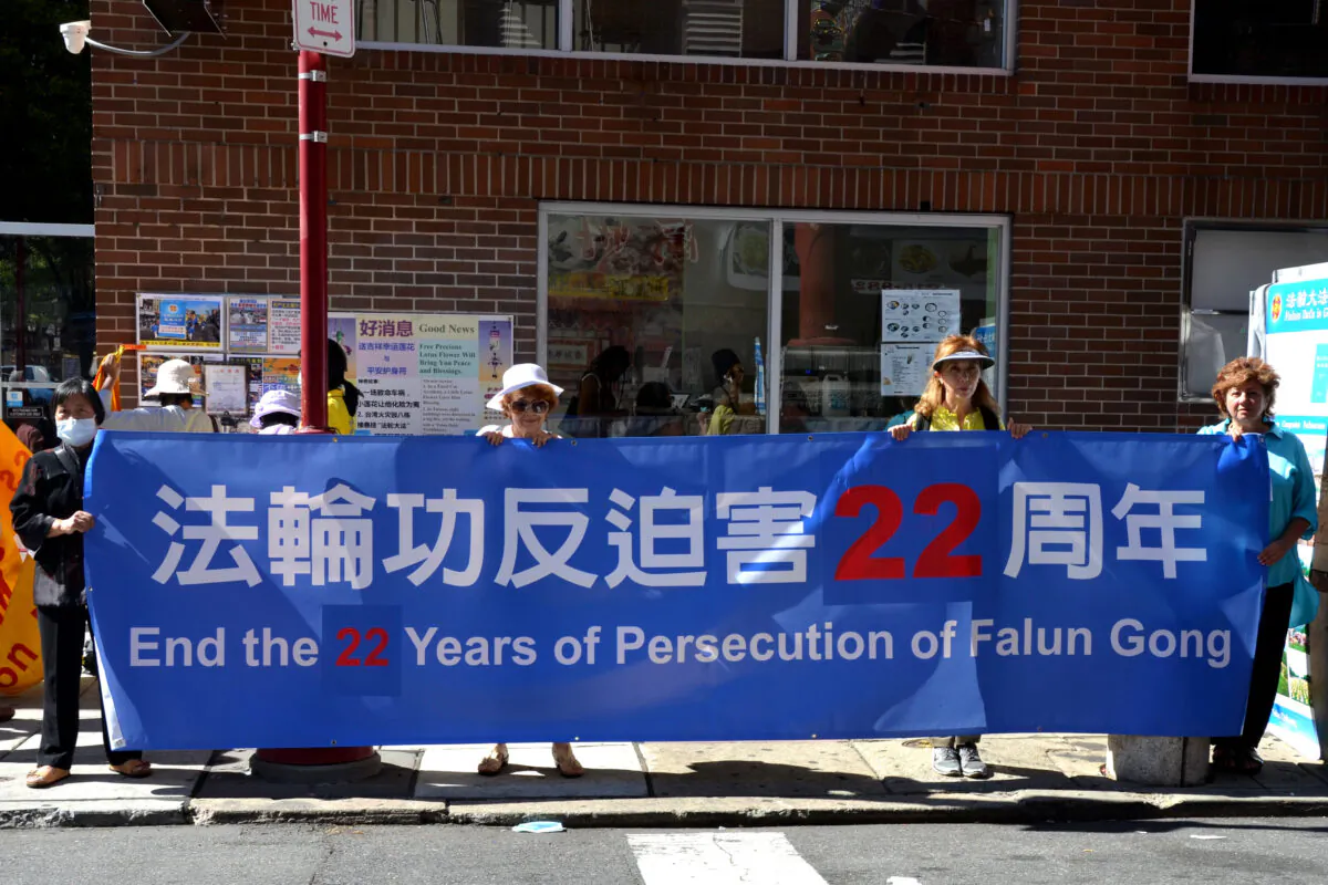 People participate in a rally to denounce the Chinese Communist Party (CCP) and encourage Chinese people to withdraw from the CCP and its affiliated organizations, in Philadelphia Chinatown, on Sept. 26, 2021. (Frank Liang/The Epoch Times)