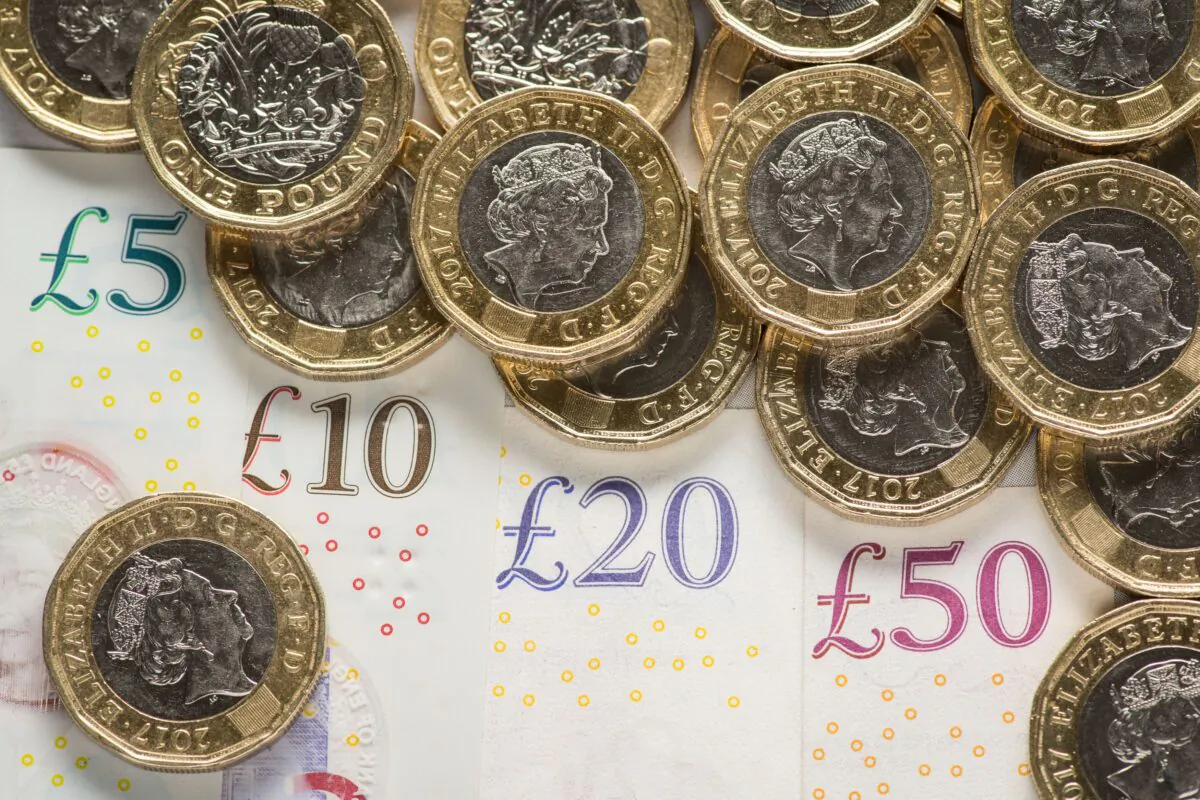 UK £5, £10, £20, and £50 notes with £1 coins, shown in a file photo dated Jan. 26, 2018. (Dominic Lipinski/PA)