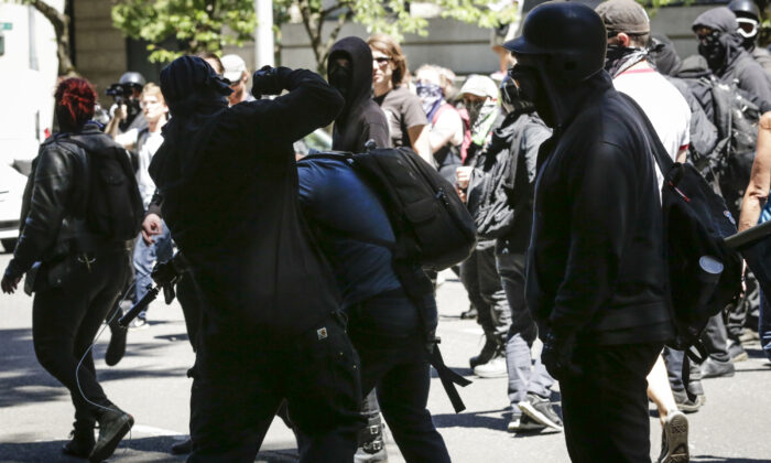 Unidentified Rose City Antifa members beat up Andy Ngo, a Portland-based journalist, in Portland, Oregon on June 29, 2019. (Moriah Ratner/Getty Images)