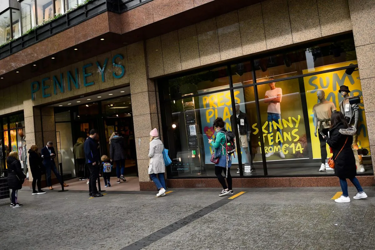 People keeping social distance queue outside a Penneys clothes shop, as a phased reopening by appointment shopping following Government guidance begins, after an extended lockdown due to the coronavirus disease outbreak, in Dublin, Ireland on May 10, 2021. (Clodagh Kilcoyne/Reuters)