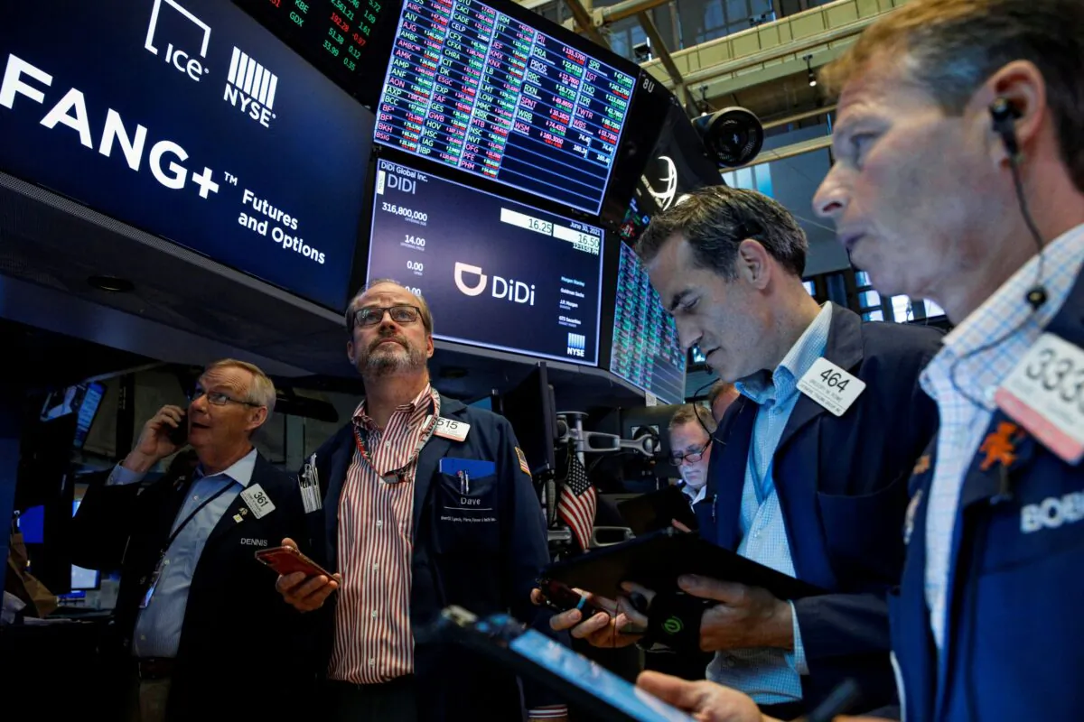Traders work during the IPO for Chinese ride-hailing company Didi Global Inc. on the New York Stock Exchange (NYSE) floor in New York City on June 30, 2021. (Brendan McDermid/Reuters)