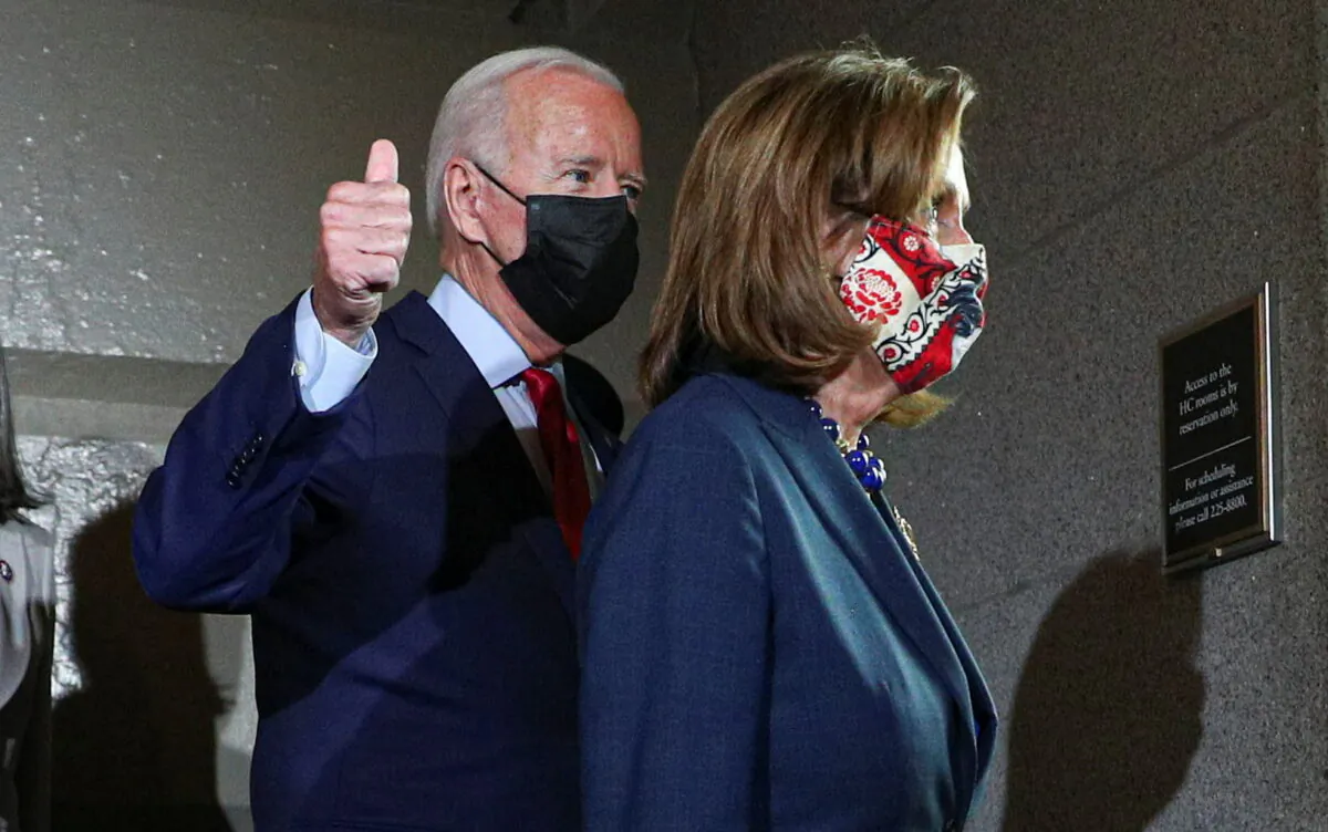 U.S. President Joe Biden gives a thumbs up as he walks with Speaker of the House Nancy Pelosi to a meeting with Democratic lawmakers at the U.S. Capitol to promote his bipartisan infrastructure bill in Washington on Oct. 1, 2021. (Tom Brenner/Reuters)