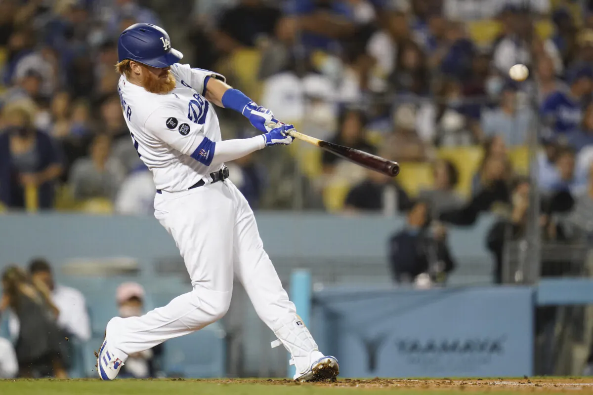 Los Angeles Dodgers' Justin Turner hits a home run during the fourth inning of a baseball game against the San Diego Padres in Los Angeles on Sept. 30, 2021. (AP Photo/Ashley Landis)