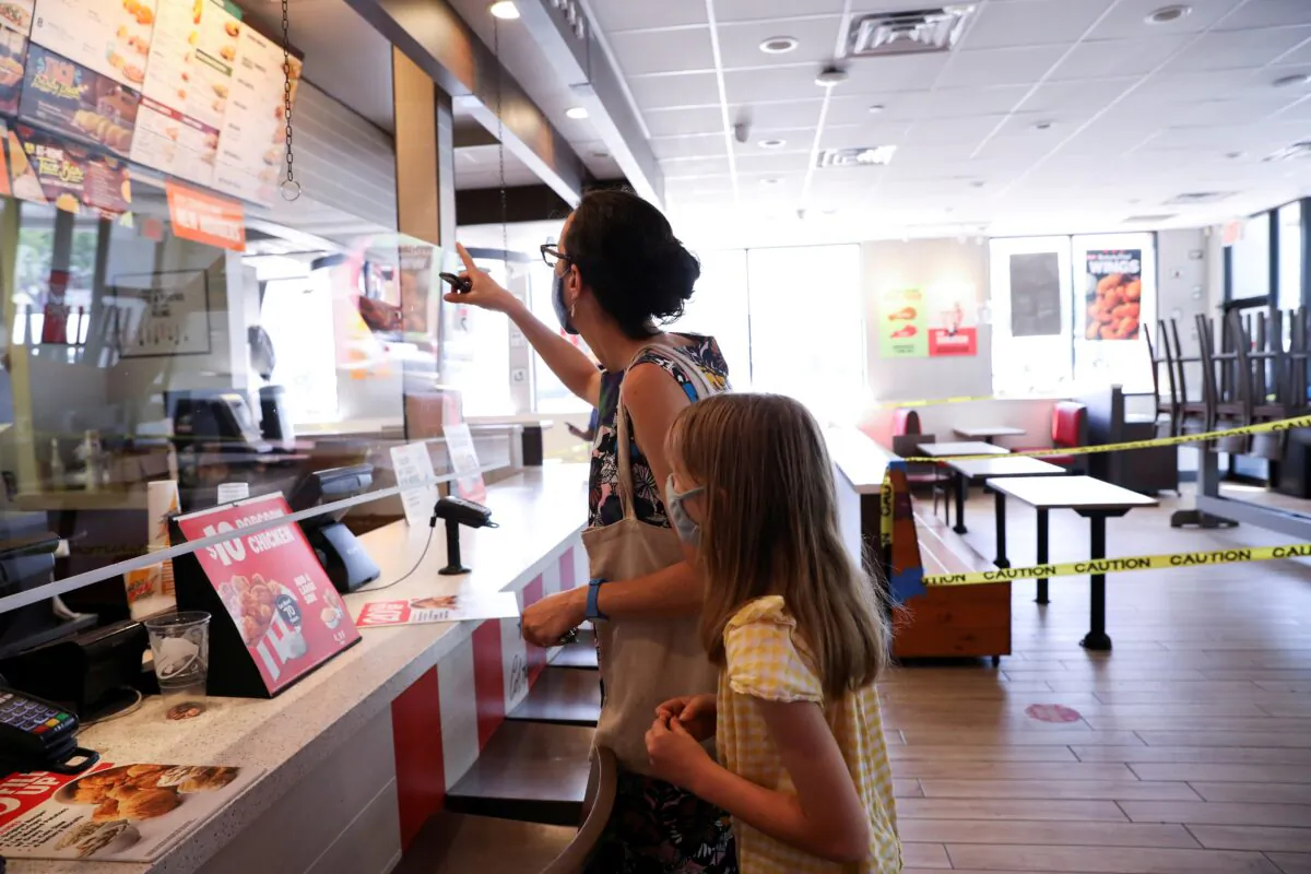 Naomi and Lydia Hassebroek order food from Taco Bell in Brooklyn, New York, on June 23, 2020. (Caitlin Ochs/Reuters)