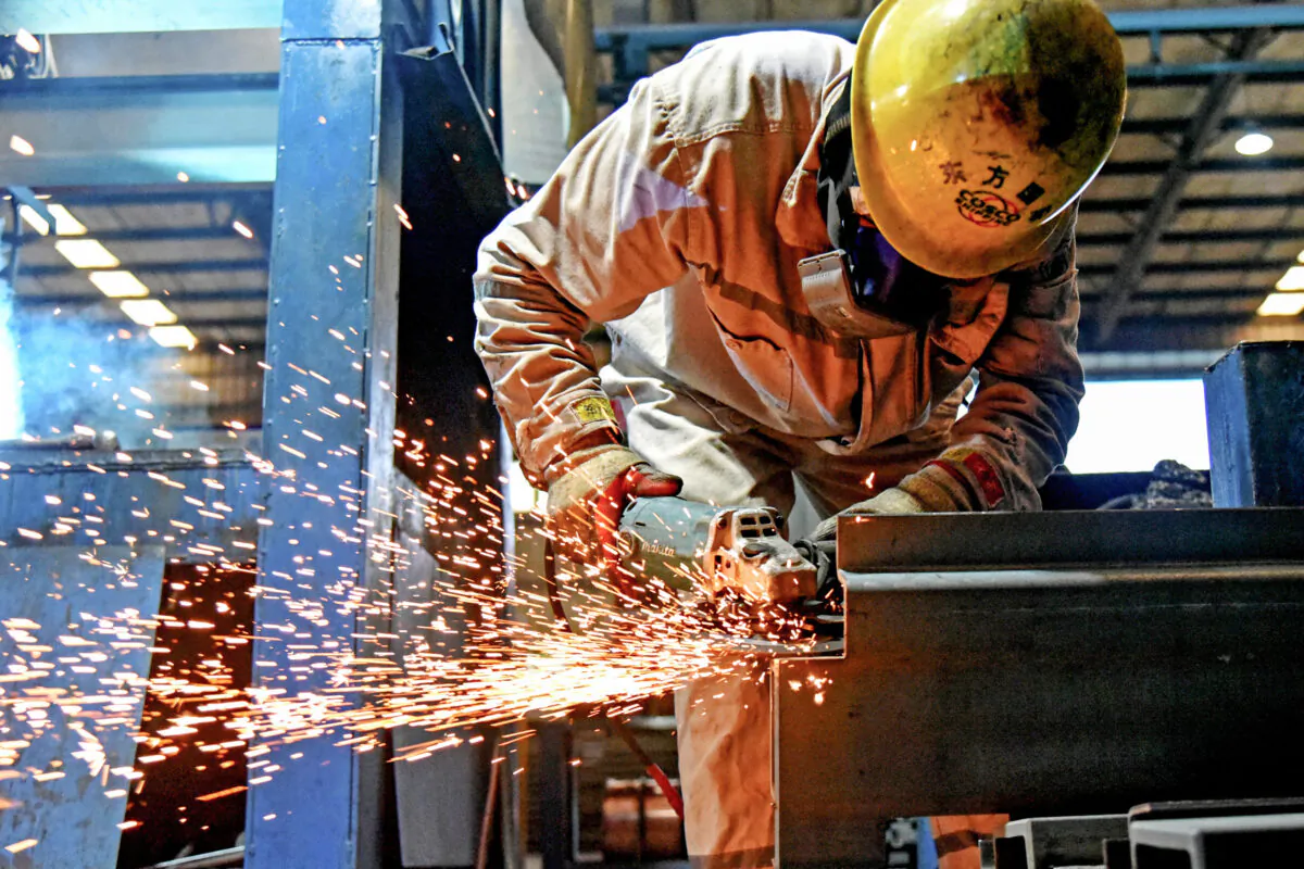 A worker uses a hand tool to make containers at a factory in Lianyungang in China's eastern Jiangsu Province on Aug. 27, 2021. (STR/AFP)