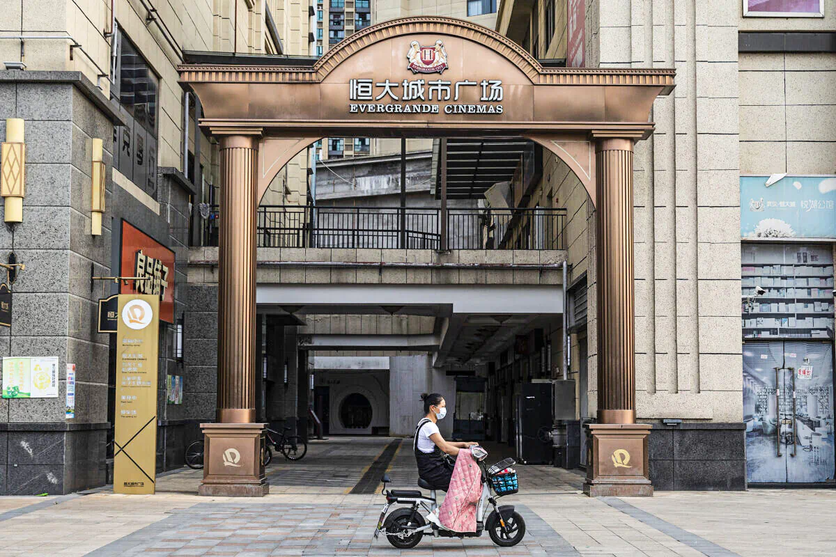 A resident wears a mask while cycling through the Evergrande City on Sept. 24, 2021 in Wuhan, Hubei Province, China. Evergrande, China's largest property developer, is facing a liquidity crisis with total debts of around $300 billion. The problems faced by the company could impact China’s economy, and the global economy at large. (Getty Images)