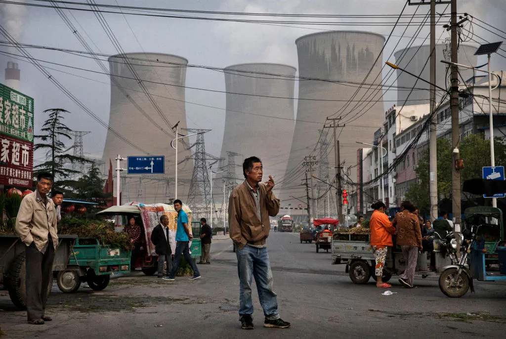 Outside a state-owned coal-fired power plant near the site of a large floating solar farm project on June 14, 2017 in Huainan, Anhui Province, China. The floating solar field is built on part of a former coal mine. The solar farm now produces enough energy to power 15,000 homes. Officials say they are planning more projects like it, in an area where long-term intensive coal mining has led to large areas of ground sinking and environmental degradation. China remains the planet's top emitter of greenhouse gases and accounts for about half of the world's total coal consumption. (Kevin Frayer/Getty Images)