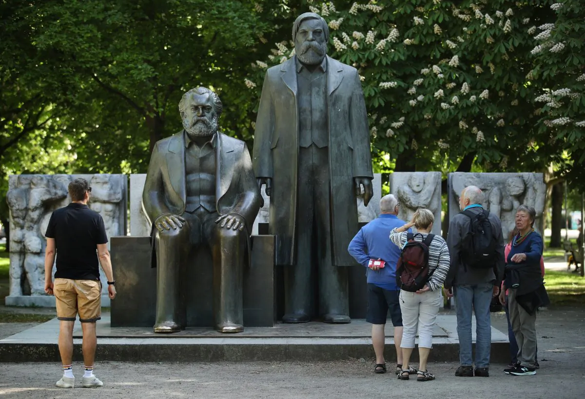 Visitors look at statues of Karl Marx (L) and Friedrich Engels in a park in Berlin, Germany, on May 4, 2018. The illusions that many in the West hold about socialism today mirror the experiences of countless impressionable young people who embraced communism in the last century in the Soviet Union, China, and elsewhere. (Sean Gallup/Getty Images)