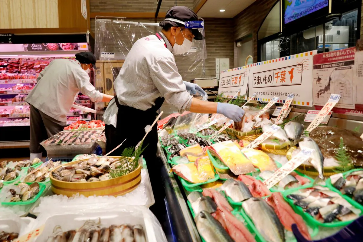 A staff wearing a face shield sells fish at Japan's supermarket group Aeon's shopping mall as the mall reopens amid COVID-19 outbreak in Chiba, Japan, on May 28, 2020. (Kim Kyung-Hoon/Reuters)