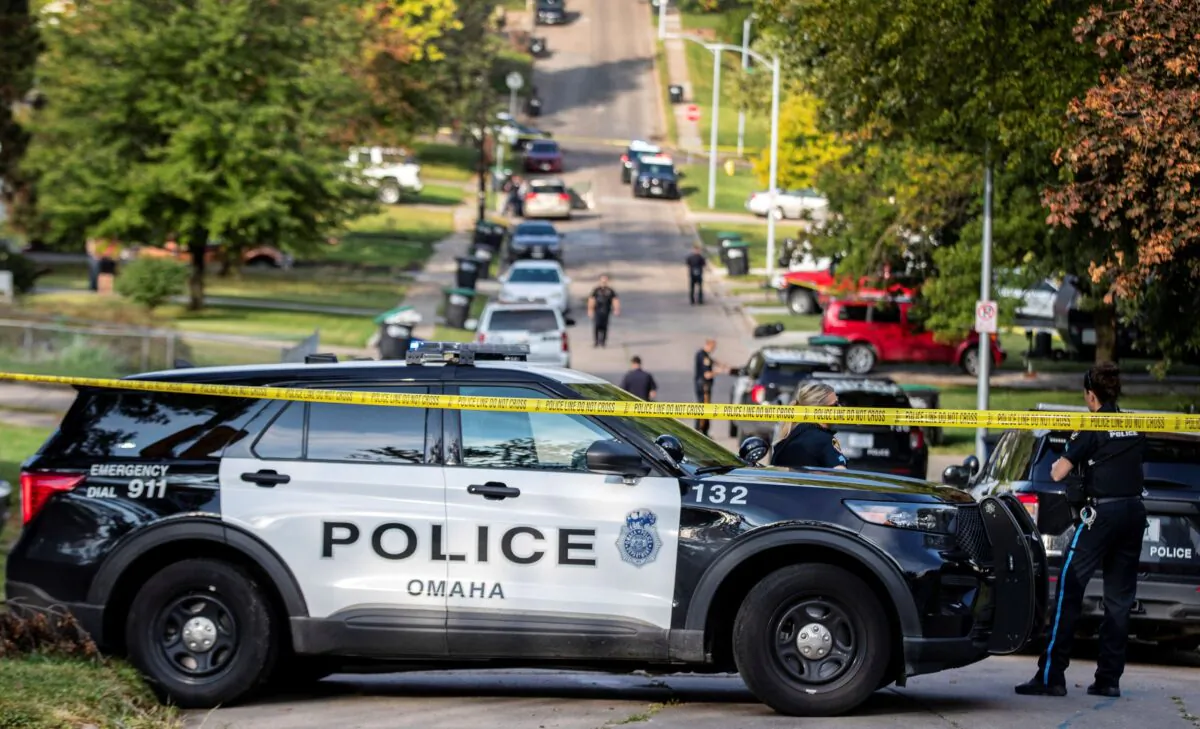 Police cordon off a road as they investigate the death of Christopher Gradoville, the director of baseball operations at Creighton University in Omaha, Neb., on Sept. 30, 2021, (Chris Machian/Omaha World-Herald via AP)