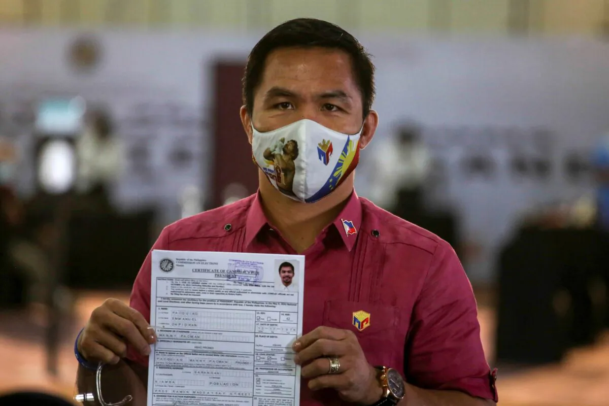 Retired Filipino boxing star and senator Manny Pacquiao shows his certificate of candidacy for next year's presidential elections at the Sofitel Harbor Garden Tent in Manila, Philippines on Oct. 1, 2021. (Jam Sta Rosa/Photo via AP)