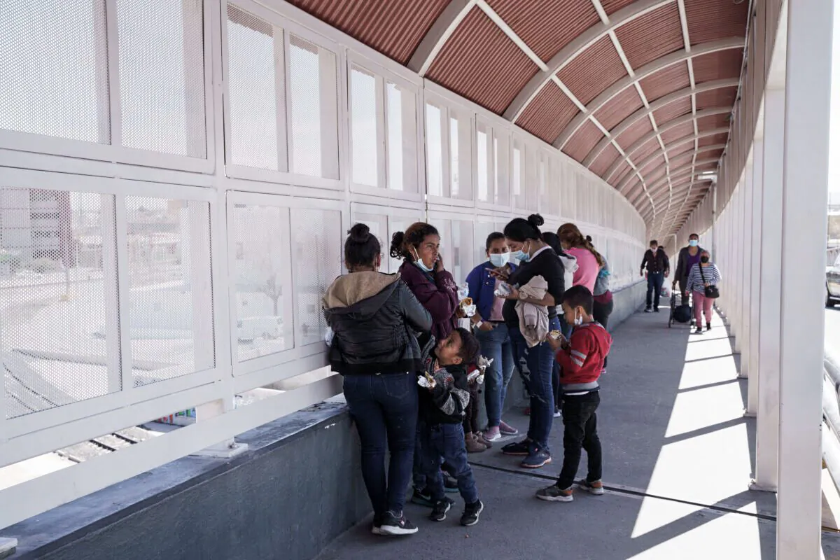 A group of illegal immigrants rapidly deported from the United States under Title 42 wait on the Mexican side of the Paso del Norte International Bridge between El Paso, Texas, and Ciudad Juarez, Mexico on March 10, 2021. (Paul Ratje/AFP via Getty Images)