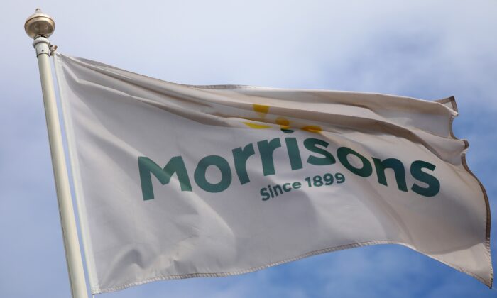 A flag flies outside a Morrisons supermarket in New Brighton, Britain, on July 5, 2021. (Phil Noble/Reuters)