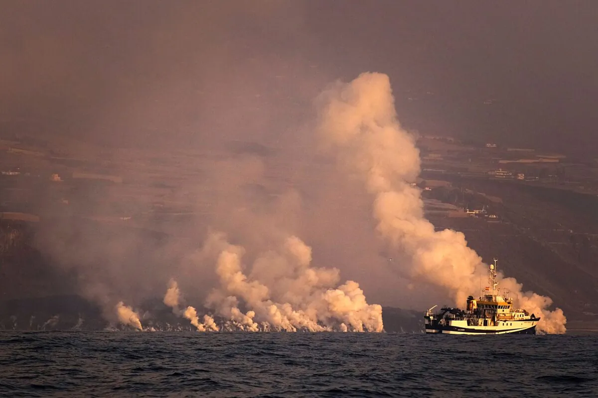 A cloud of gases are seen as lava from a volcano enters the sea on the Canary island of La Palma, Spain, on Sept. 30, 2021. (Daniel Roca/AP Photo)