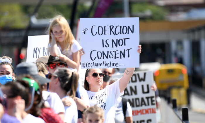 Protesters march across Victoria Bridge during a rally against Covid-19 vaccine mandates, in Brisbane, Australia. #ReclaimTheLine rallies across Australia, on Oct. 1, 2021. (Dan Peled/Getty Images)