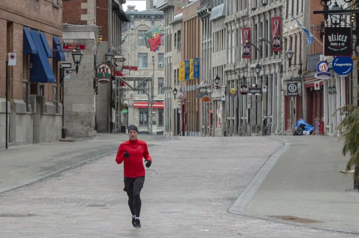 A runner makes his way through the empty streets of Old Montreal on April 1, 2020. (The Canadian Press/Ryan Remiorz)