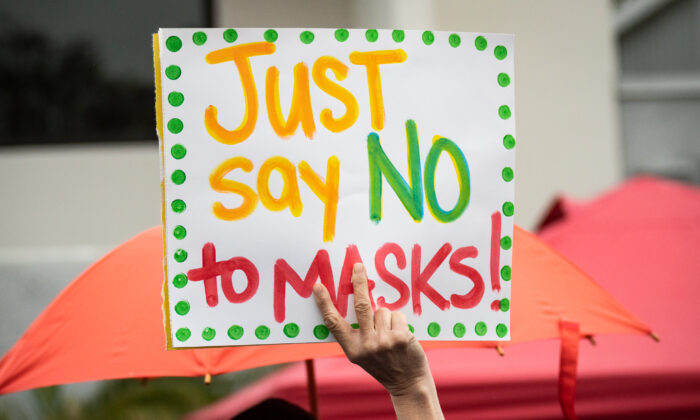Parents and students gather in protest of wearing masks in schools in front of The Orange County Board of Education in Costa Mesa, Calif., on May 17, 2021. (John Ferdricks/The Epoch Times)