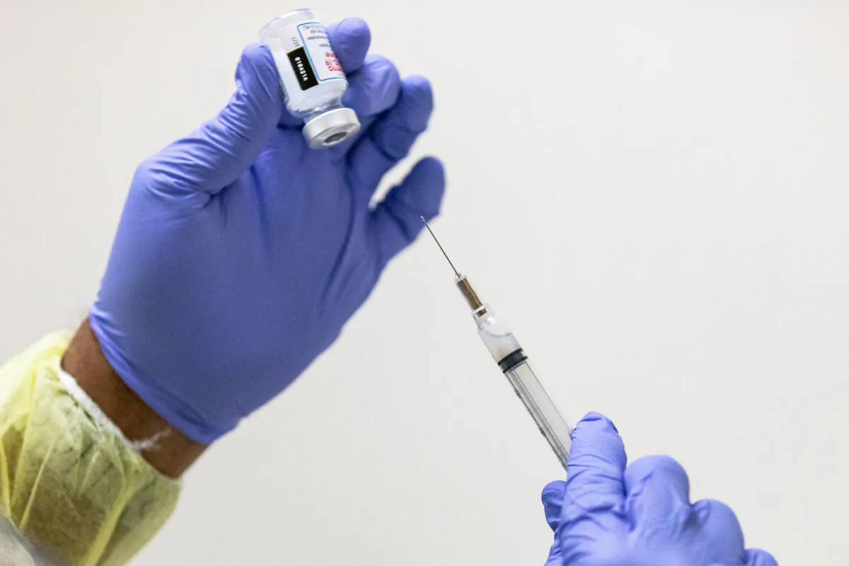 A medical volunteer prepares the Moderna COVID-19 vaccine for a patient at Lestonnac Free Clinic in Orange, Calif., on March 9, 2021. (John Fredricks/The Epoch Times)
