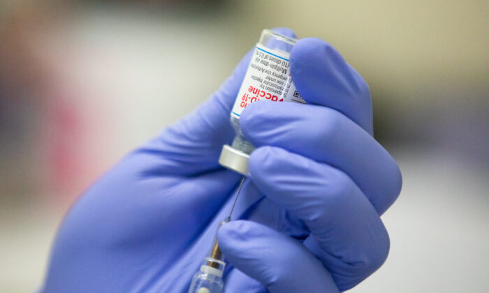 A medical volunteer prepares the Moderna COVID-19 vaccine for a patient at Lestonnac Free Clinic in Orange, Calif., on March 9, 2021. (John Fredricks/The Epoch Times)