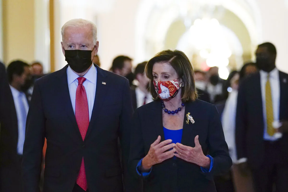 President Joe Biden walks with House Speaker Nancy Pelosi (D-Calif.) on Capitol Hill in Washington on Oct. 1, 2021. (Susan Walsh/AP Photo)