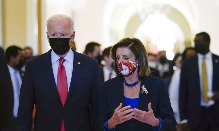 President Joe Biden walks with House Speaker Nancy Pelosi (D-Calif.) on Capitol Hill on Oct. 1, 2021. (Susan Walsh/AP Photo)