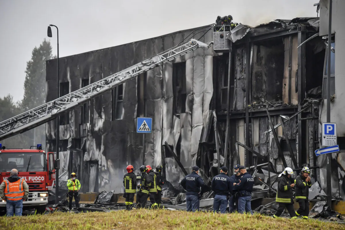 Firefighters work on the site of a plane crash, in San Donato Milanese suburb of Milan, Italy, on Oct. 3, 2021. (Claudio Furlan/LaPresse via AP)