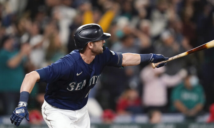 Seattle Mariners' Mitch Haniger singles in a pair of runs against the Los Angeles Angels in the eighth inning of a baseball game in Seattle on Oct. 2, 2021. (AP Photo/Elaine Thompson)