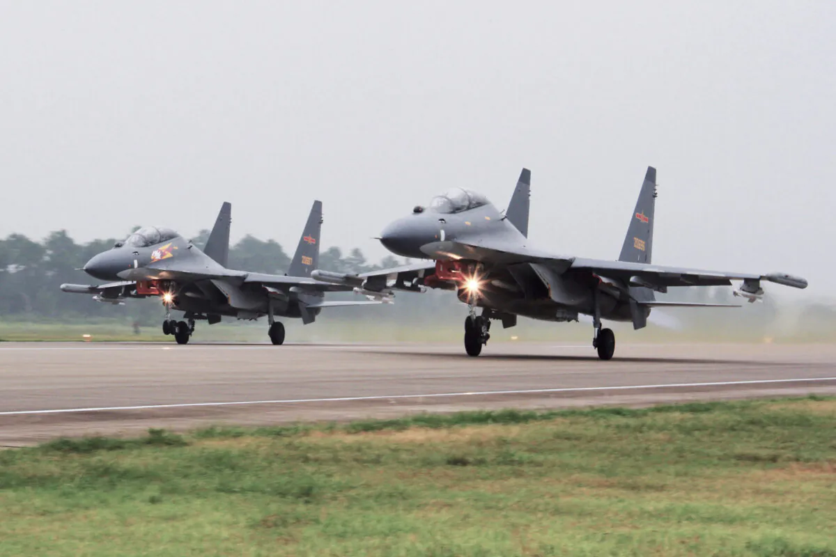 Two Chinese SU-30 fighter jets take off from an unspecified location to fly a patrol over the South China Sea, in this file photo. (Jin Danhua/Xinhua via AP)
