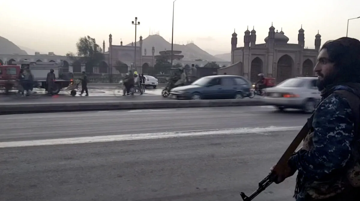 An armed Taliban terrorist on a busy street opposite Eidgah Mosque where a deadly blast occurred in Kabul, Afghanistan, on Oct. 3, 2021. (Reuters/Screenshot via NTD)