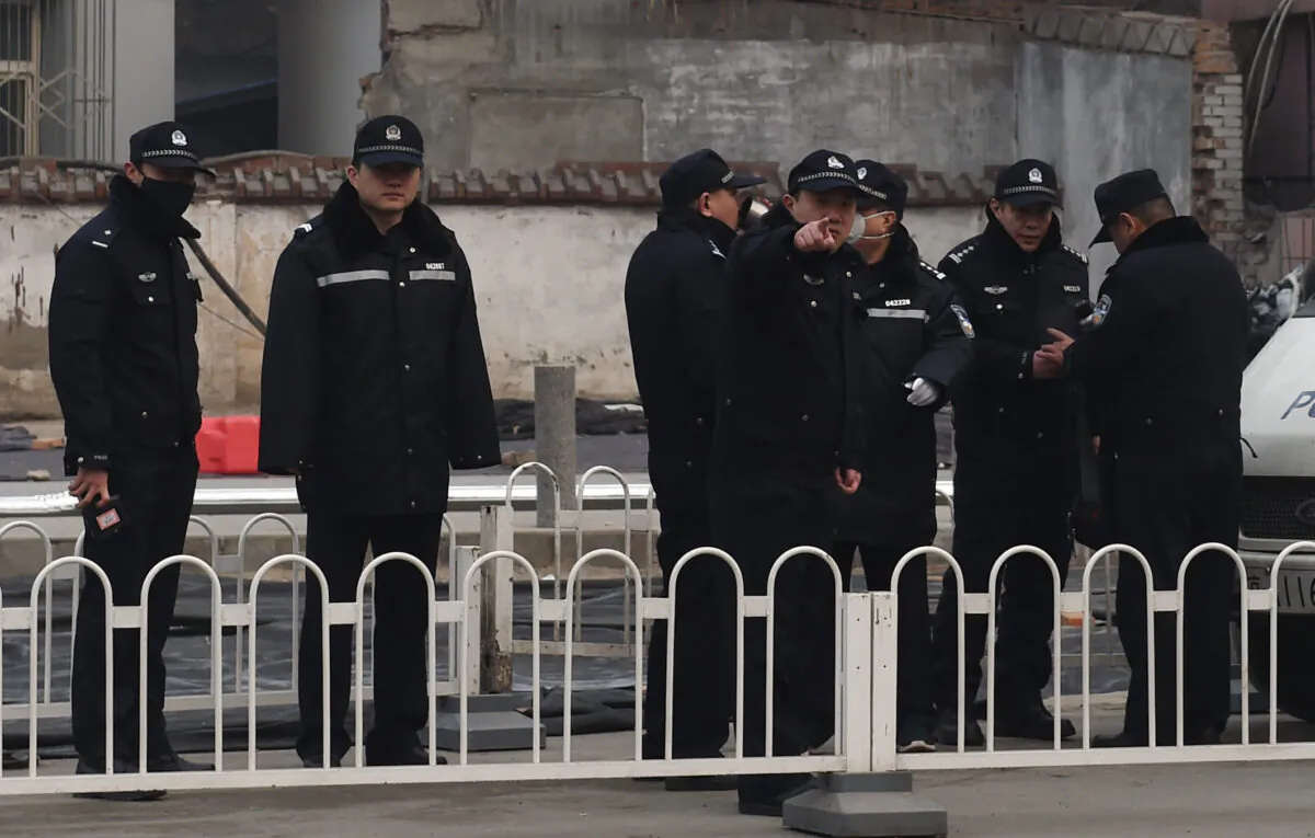 Police officers stand guard outside the No. 2 Intermediate People's Court where human rights lawyer Pu Zhiqiang was being sentenced in Beijing on Dec. 22, 2015. (Greg Baker/AFP via Getty Images)