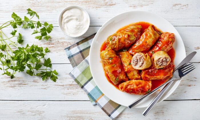 se Polish-style cabbage rolls call for softened cabbage leaves wrapped around a grain and meat filling, simmered for hours in a tomato-based sauce. (from my point of view/shutterstock)