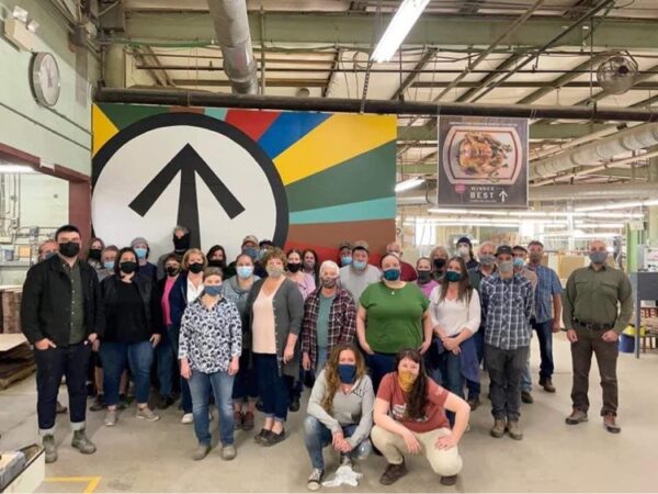 Masked employees of JK Adams in Dorset, VT pose for a group photo. (Photo courtesy of JK Adams Facebook Page)