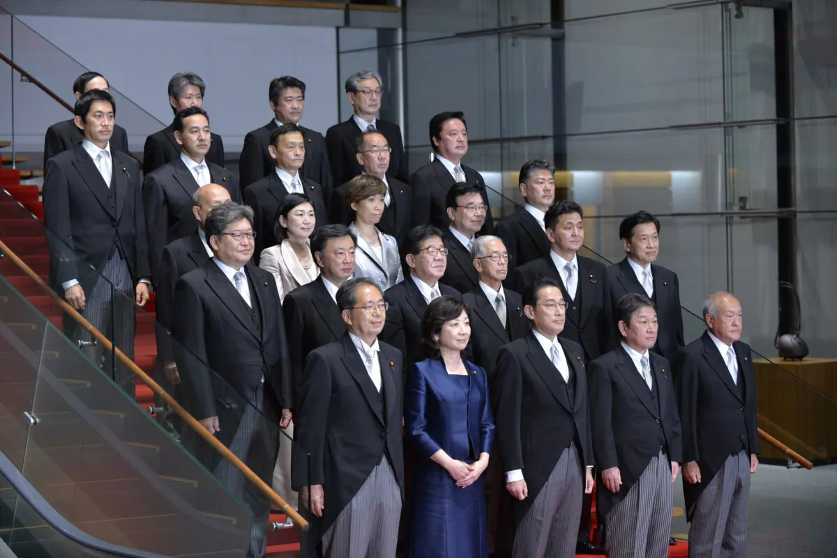Newly elected Japanese Prime Minister Fumio Kishida (center) poses with his cabinet members at the prime minister's official residence in Tokyo, Japan, on Oct. 4, 2021. (David Mareuil/Pool/Getty Images)