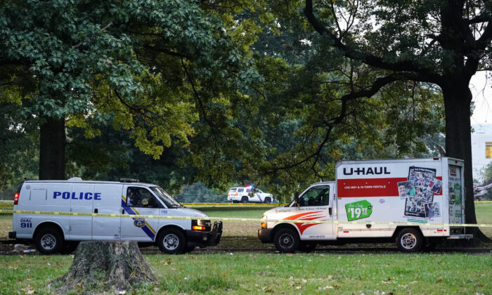 Police vehicles and a U-Haul truck are shown at a crime scene in Philadelphia, on Oct. 4, 2021. (Matt Rourke/AP Photo)