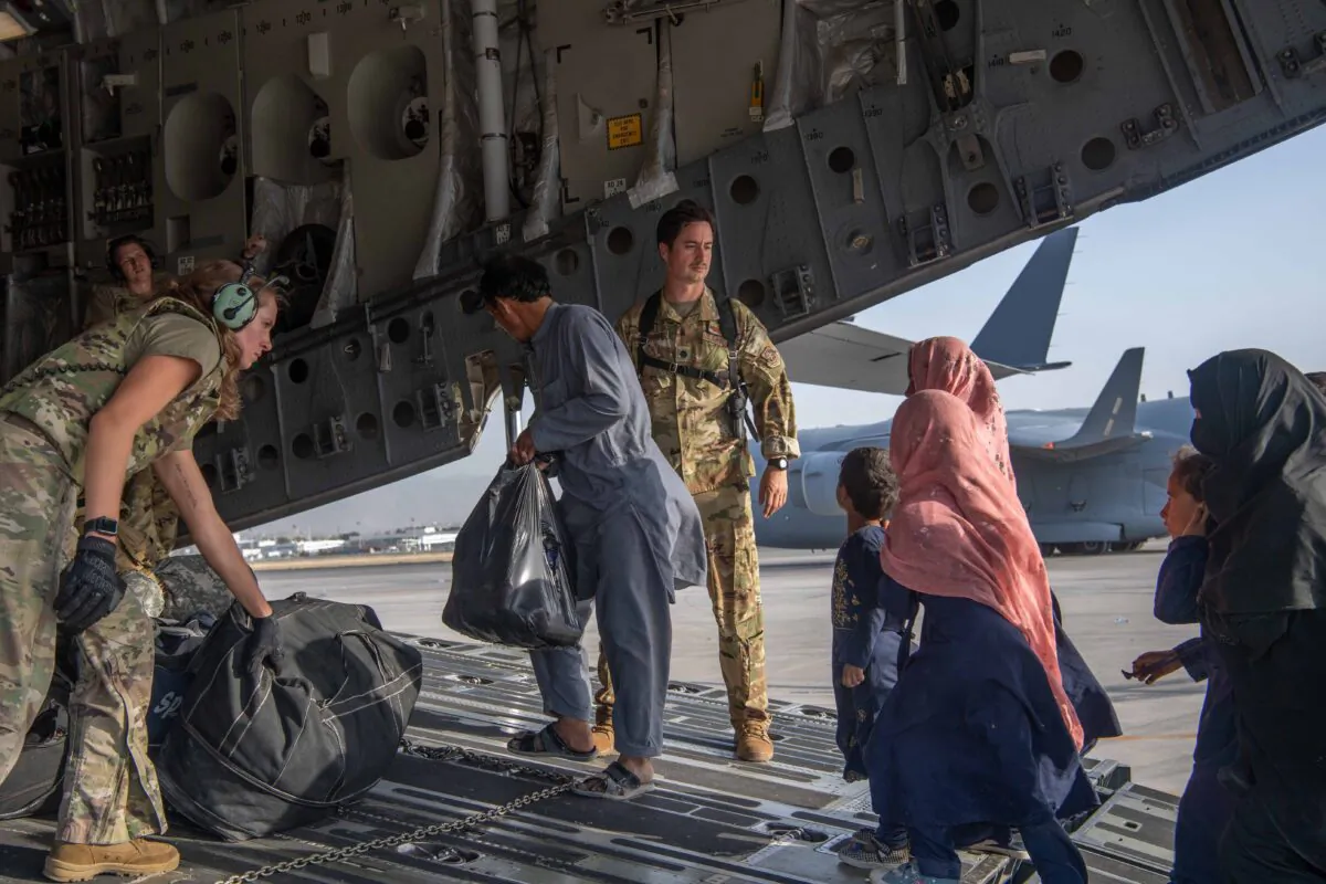 U.S. Air Force loadmasters and pilots load passengers during the Afghanistan evacuation at Hamid Karzai International Airport (HKIA) on Aug. 24, 2021, in Kabul, Afghanistan. (Master Sgt. Donald R. Allen/U.S. Air Forces Europe-Africa via Getty Images)