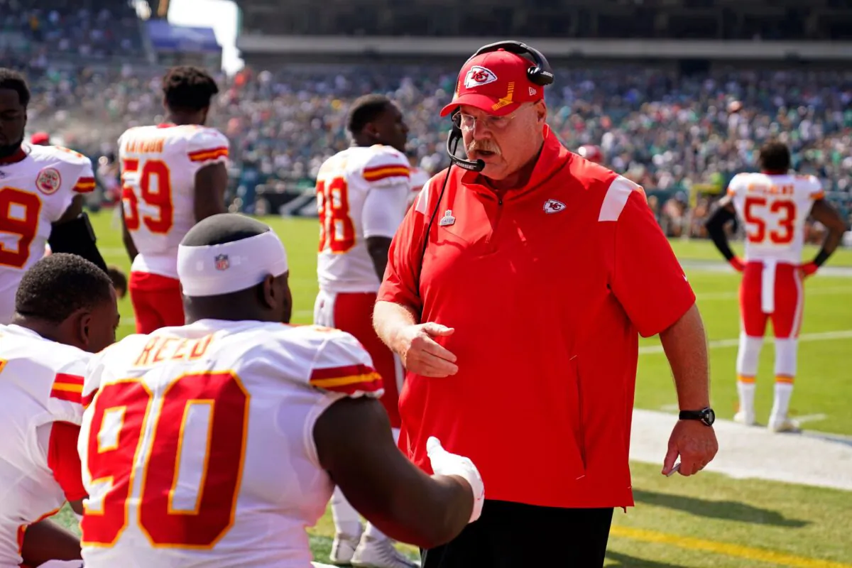 Kansas City Chiefs head coach Andy Reid talks to Kansas City Chiefs defensive tackle Jarran Reed (90) before an NFL football game against the Philadelphia Eagles in Philadelphia, Pa., on Oct. 3, 2021. (Matt Rourke/AP Photo)