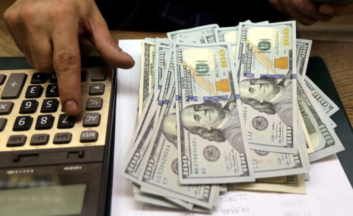 An employee counts U.S. dollar bills at a money exchange in central Cairo, Egypt, on March 20, 2019. (Mohamed Abd El Ghany/Reuters)