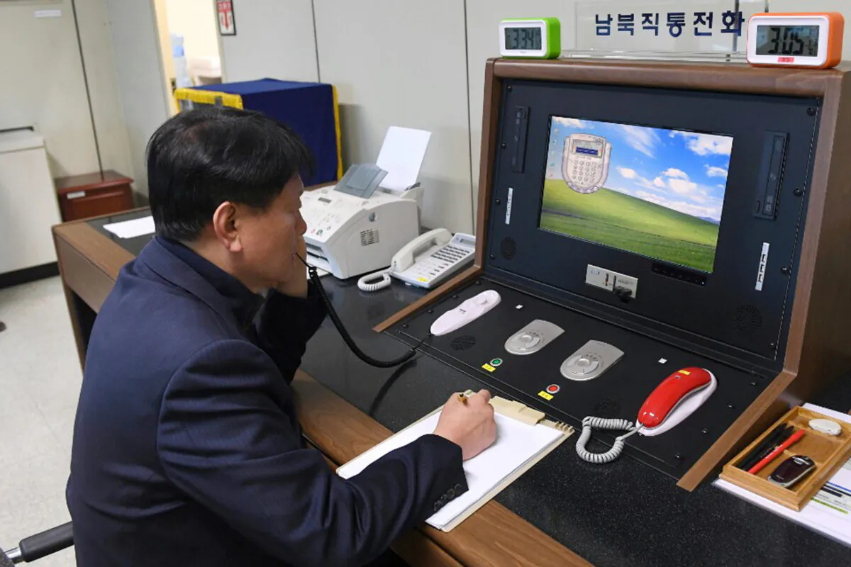 A South Korean government official communicates with a North Korean officer during a phone call on the dedicated communications hotline at the border village of Panmunjom in Paju, South Korea, on Jan. 3, 2018. (South Korea Unification Ministry/Yonhap via AP)