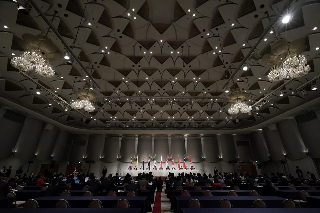Japan's Economy Minister Toshimitsu Motegi, centre, sits with other ministers and delegates of a Pacific Rim trade bloc during a joint press conference after a session of the Comprehensive and Progressive Trans-Pacific Partnership (CPTPP) in Tokyo, on Jan. 19, 2019. Canada is giving China the cold shoulder over its interest in joining an 11-country Pacific Rim trading bloc that it views as an important gateway to diversifying the country's trade with other Asian countries. (The Canadian Press/AP-Eugene Hoshiko)