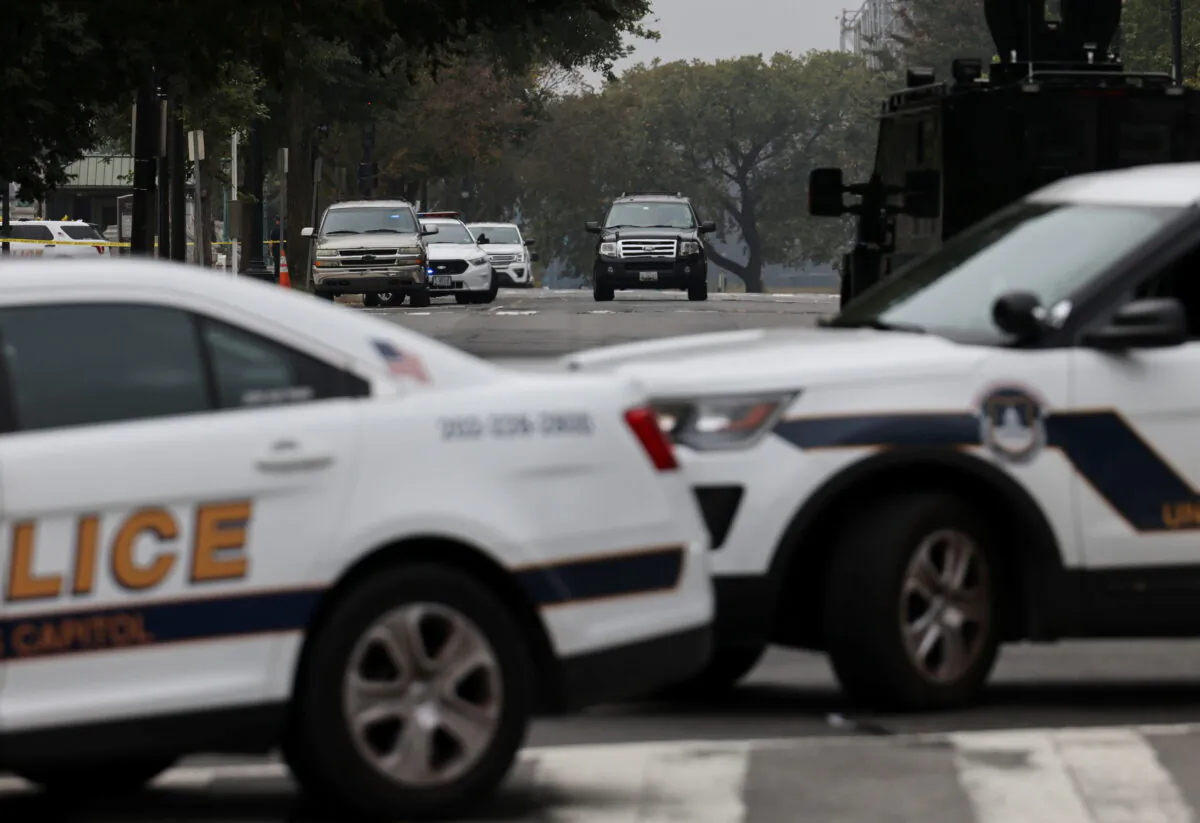 An SUV is seen (C) as U.S. Capitol Police vehicles block a street while investigating reports of a suspicious vehicle in front of the U.S. Supreme Court in Washington, on Oct. 5, 2021. (Evelyn Hockstein/Reuters)