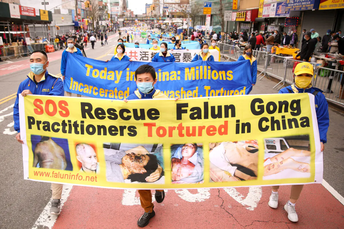 Falun Gong practitioners take part in a parade in Flushing, New York, on April 18, 2021, to commemorate the 22nd anniversary of the April 25th peaceful appeal of 10,000 Falun Gong practitioners in Beijing. (Samira Bouaou/The Epoch Times)