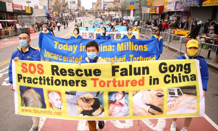 Falun Gong practitioners take part in a parade in Flushing, New York, on April 18, 2021, to commemorate the 22nd anniversary of the April 25th peaceful appeal of 10,000 Falun Gong practitioners in Beijing. (Samira Bouaou/The Epoch Times)